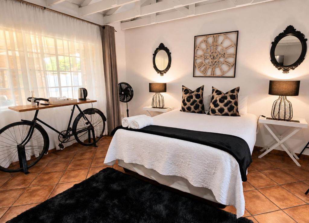 a bedroom with a bed and a bike in it at Zhantique Guest House 1- Unit 4 in Boksburg