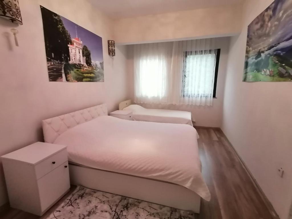 a small bedroom with a white bed and a window at Erme Dinlenme Tesisleri in Dernekpazarı