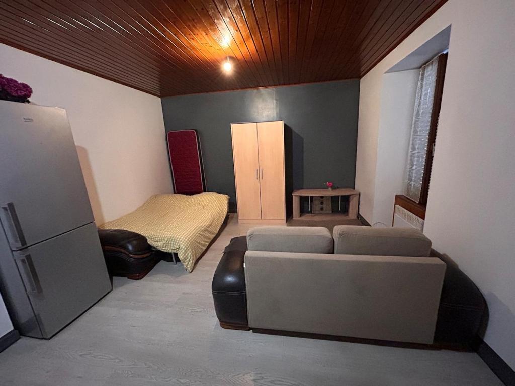 a living room with a couch and a bed at Studio à Pontarlier in Pontarlier