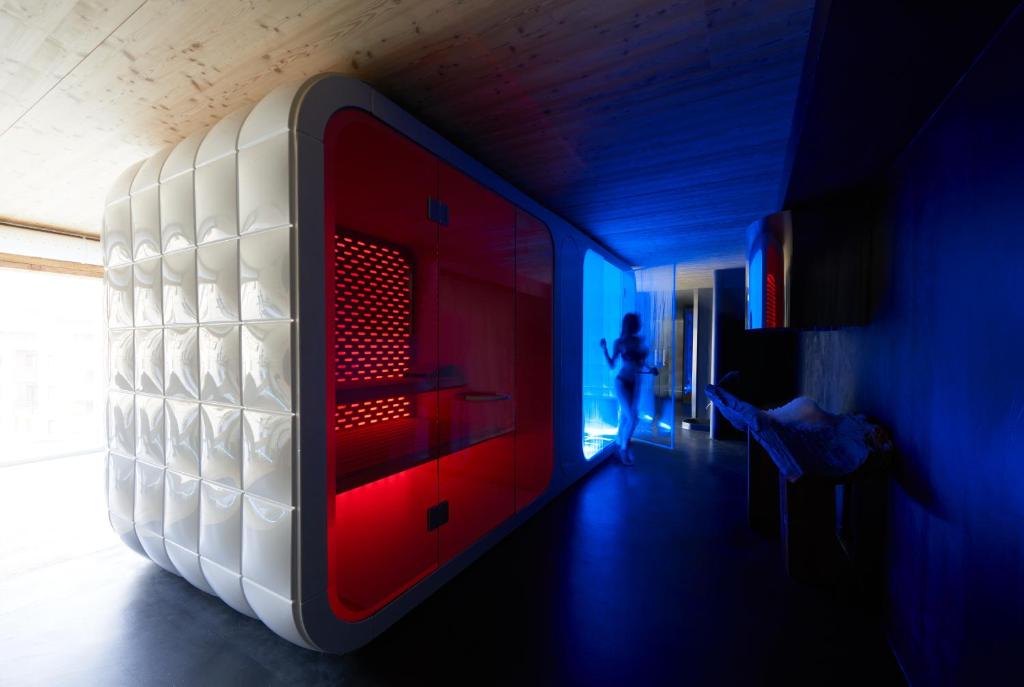 a person is standing in a room with a bed at Aux Pieds du Roi - Suite & Spa in Breuil-Cervinia