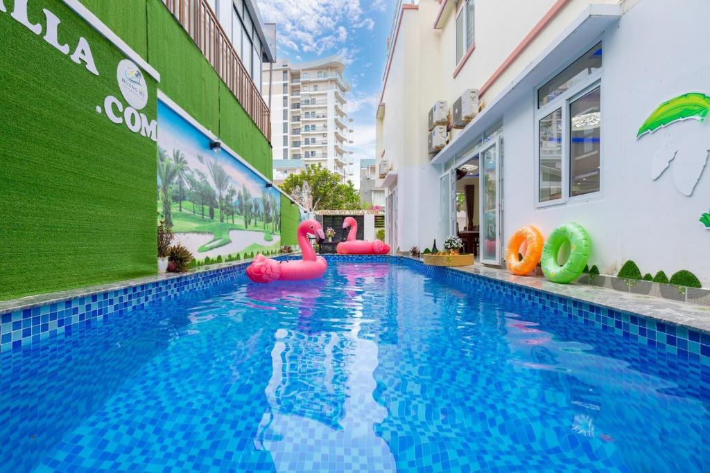 a swimming pool with inflatables in front of a building at Villa Long Cung B2-9 in Vung Tau