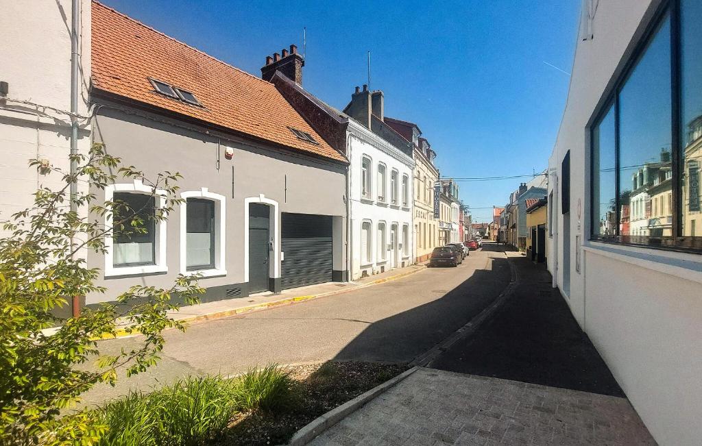 an empty street with white buildings on the side at Appartement Proche Touquet in Étaples