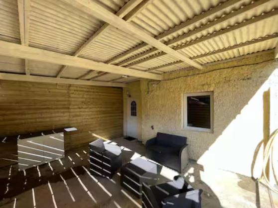 a room with chairs and a table in a room at Studio avec terrasse in Château-lʼÉvêque