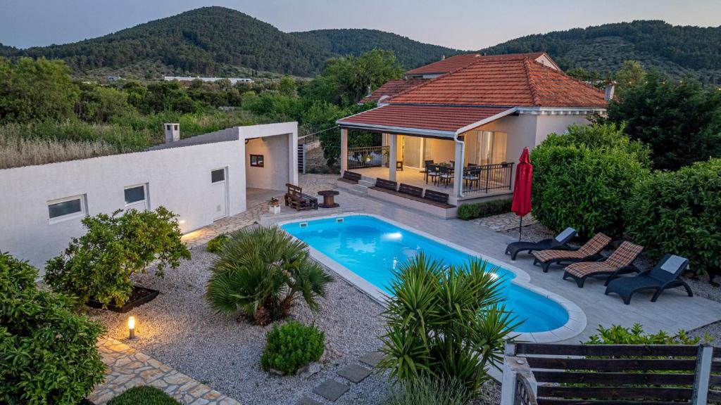 a home with a swimming pool and a house at MAB Sweet Home By Villas Guide in Vela Luka