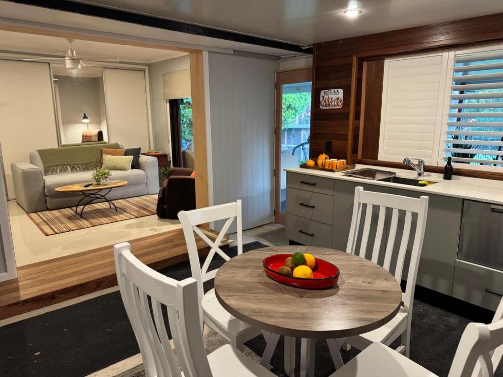 a kitchen and living room with a table and chairs at The Sanctuary on William - Nature Reserve Hideaway in Ormiston