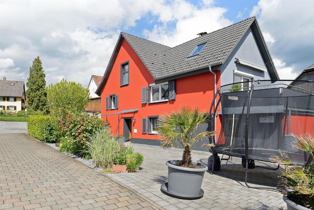 a red house with a black roof and some plants at Ferienhaus Sieger in Salem