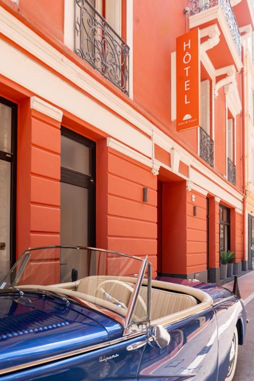 a blue car parked in front of a building at Hôtel de France in Monte Carlo