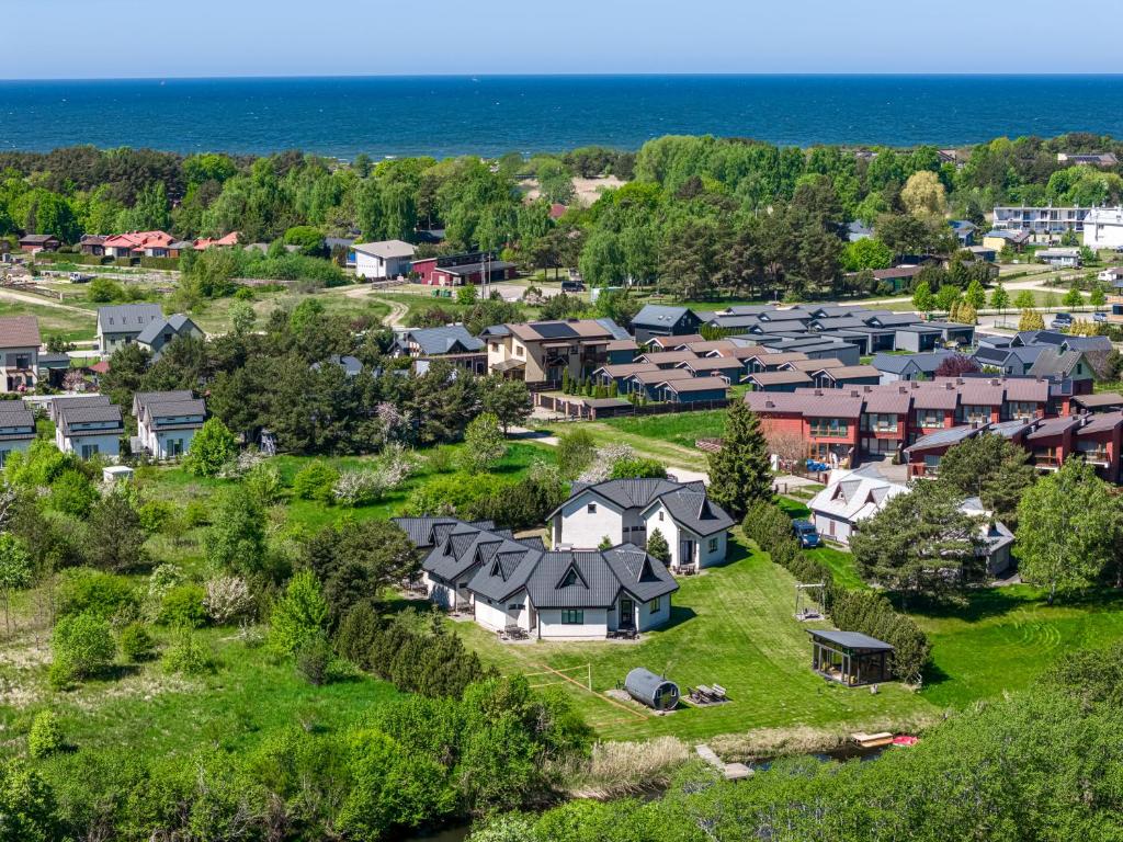 an aerial view of a small town with houses at Apartamentai Upė in Šventoji