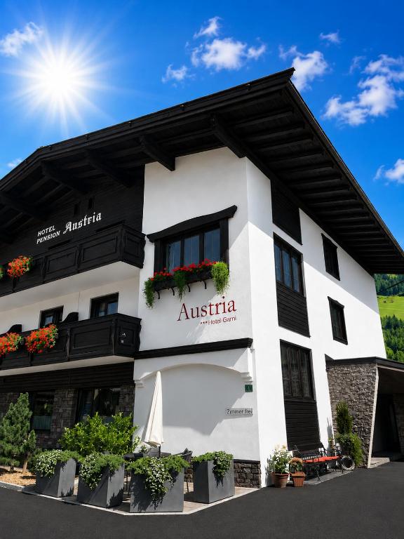 a white building with a sign that reads australia at Hotel-Garni Austria Westendorf - Tirol Erleben in Westendorf