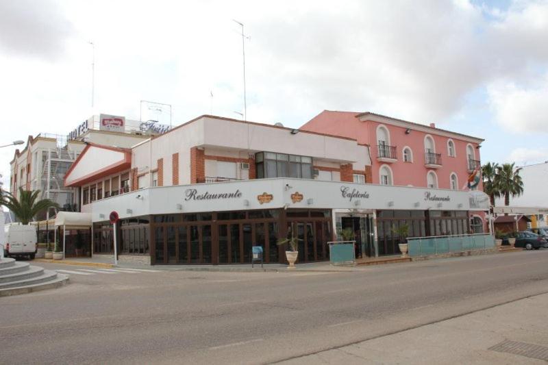 a building on the corner of a street at Hotel Frijon in Aceuchal