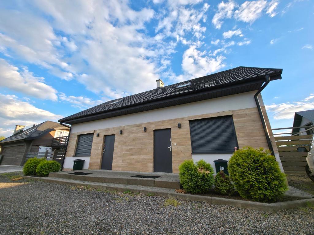 a house with a solar roof on top of it at Willa Karo dom bliźniak 7-osobowy ZE STREFĄ BASENOWĄ w miejscowości Chocznia NIEDALEKO ZATORU I ENERGYLANDII in Chocznia
