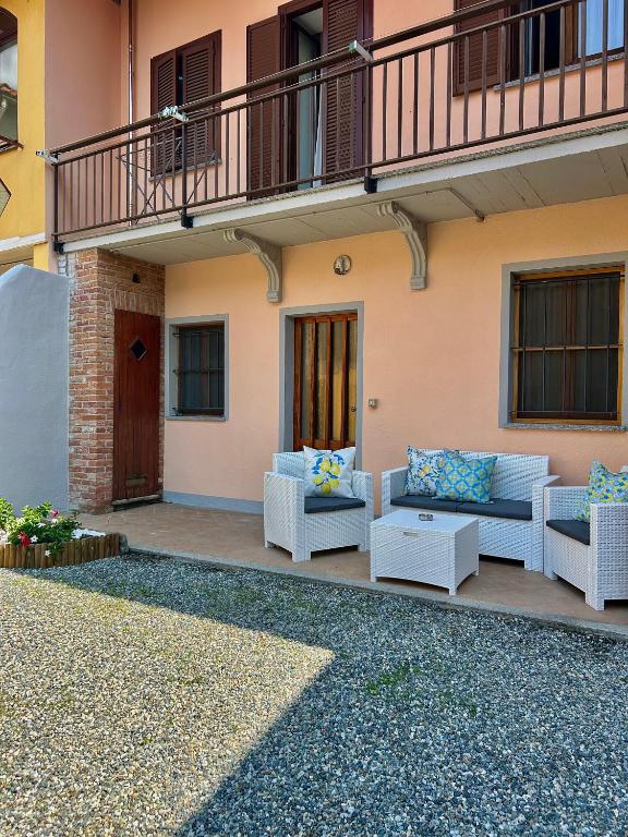 a patio with couches and tables on a building at Il Nido sul Lago B&B in Viverone