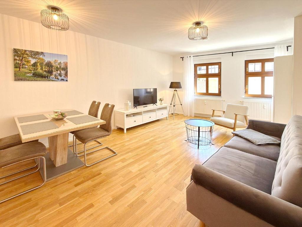 a living room with a couch and a table at Altstadtidyll in Lübbenau