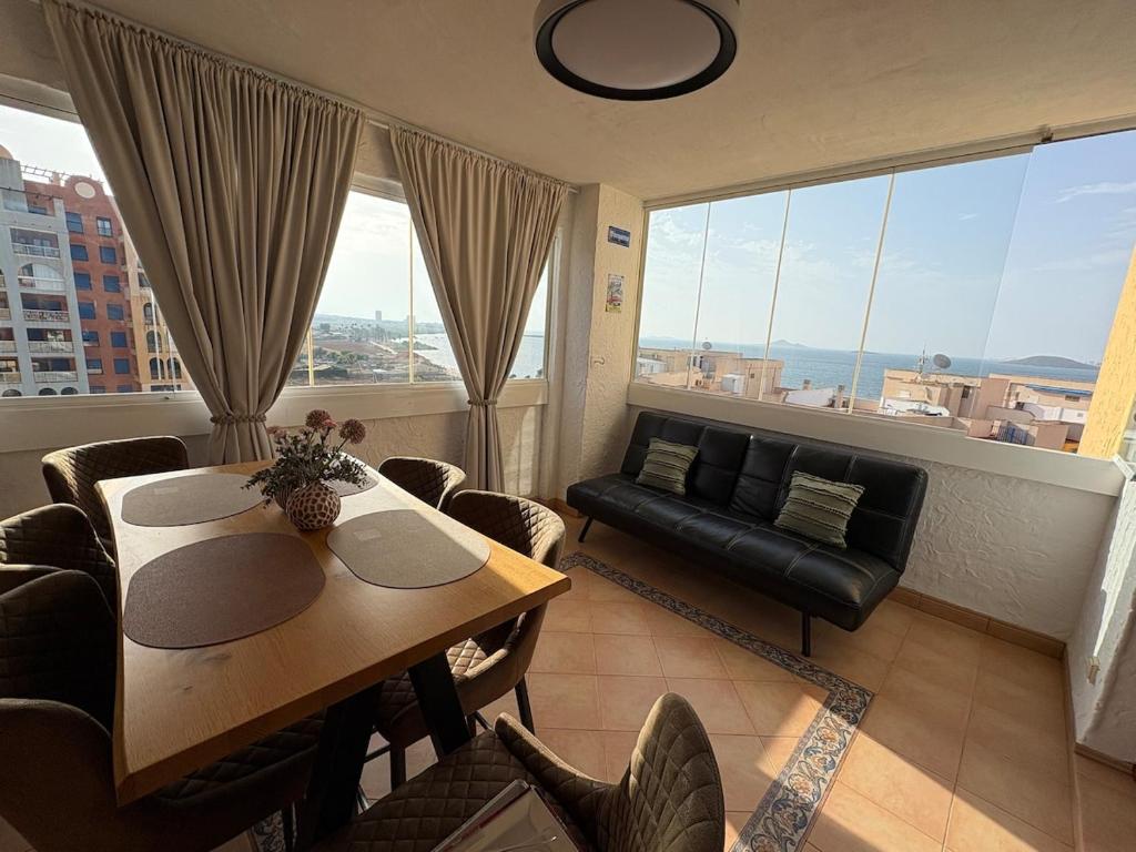 a living room with a table and chairs and a couch at HondaMar in Playa Honda