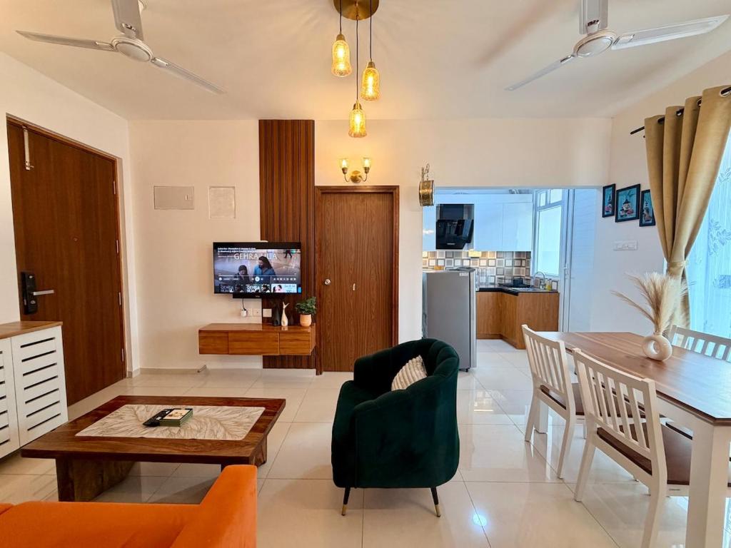 a living room with a table and a dining room at Bay Breeze 2BR Apt Amoret Homes in Chicalim