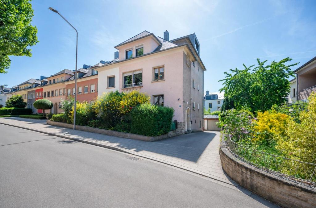 a house on a street with trees and bushes at 2 bedroom flat Bonnevoie - sleeps 7 in Luxembourg