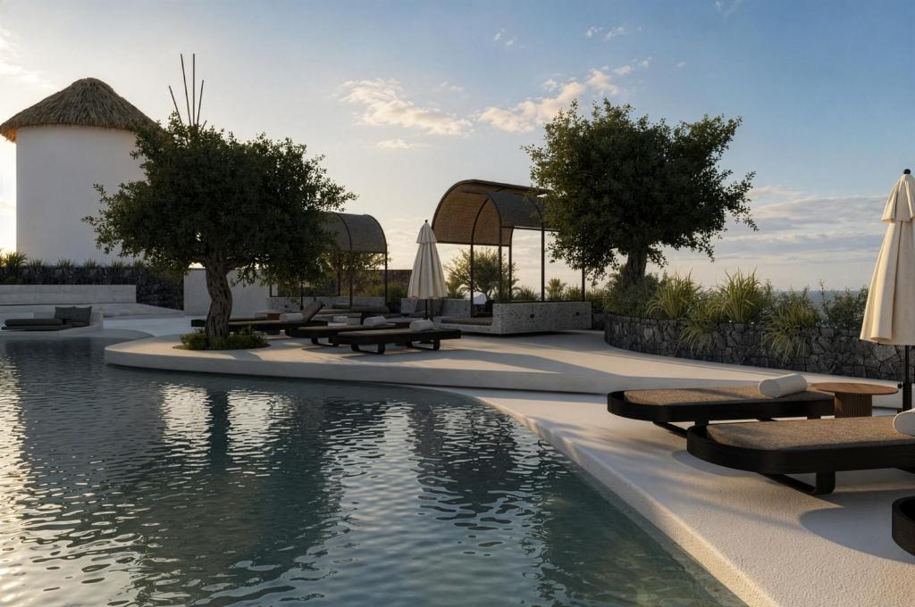 a swimming pool with tables and umbrellas next to a pool at Mamay Hotel in Fira