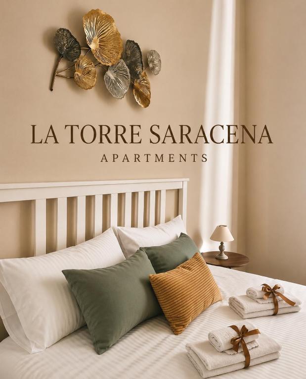 a bedroom with a bed with towels on it at LA TORRE SARACENA - APARTMENTS with services & Free Parking in Palmi