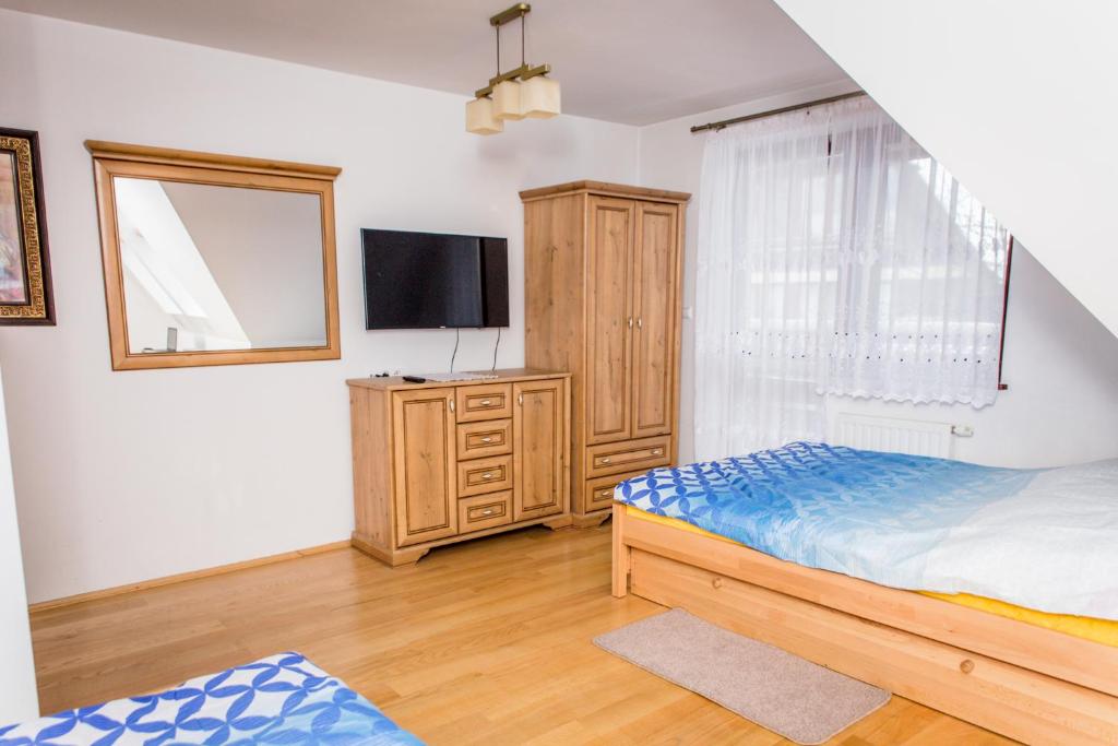 Postel nebo postele na pokoji v ubytování Zacisza Tetmajera