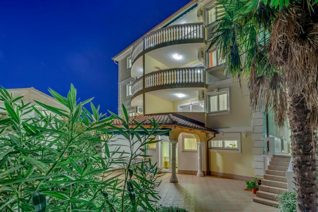 an exterior view of a building with a balcony at Apartments Villa Maria in Crikvenica