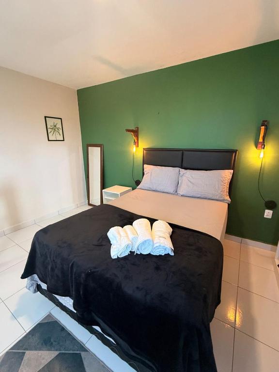 a bedroom with a bed with two towels on it at Loft Luiz Gonzaga in Campina Grande