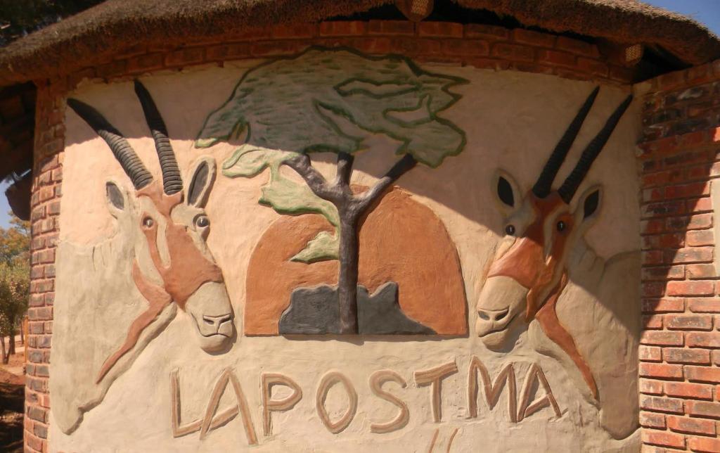 a mural of three animals on the side of a building at La Postma House in Postmasburg