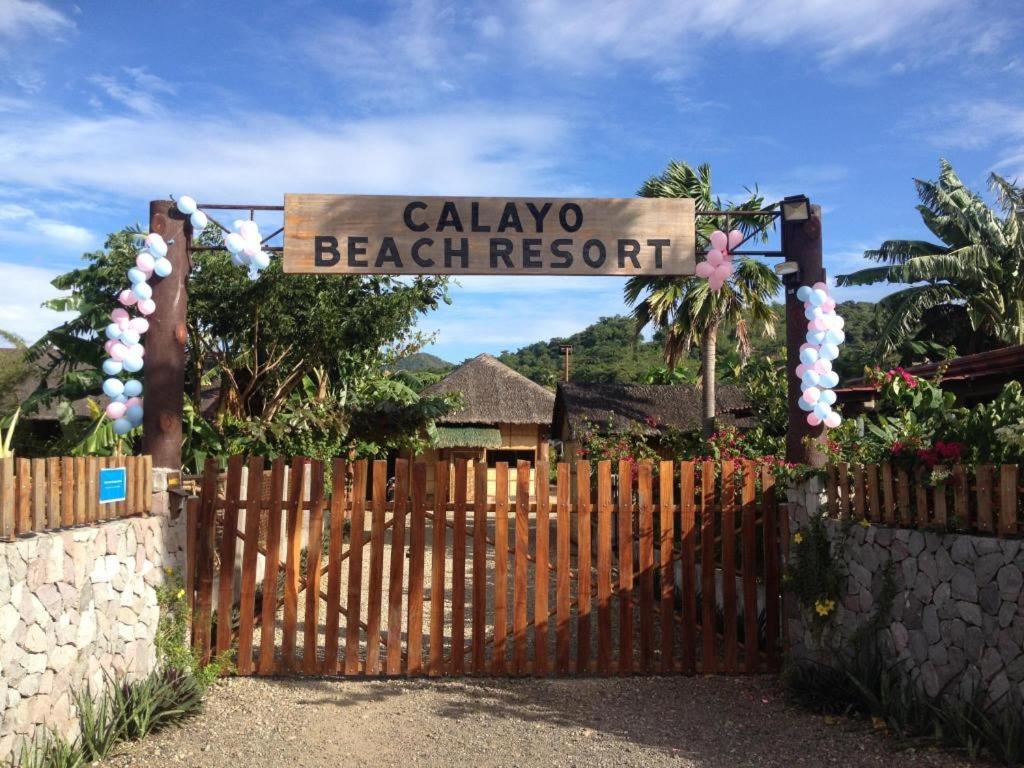 a gate with a sign that reads calaya beach resort at calayo beach resort in Calayo