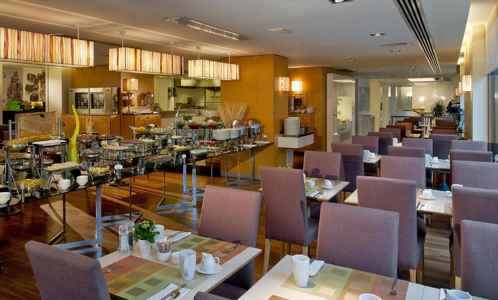 a restaurant with purple chairs and tables and a cafeteria at Divan Istanbul City in Istanbul