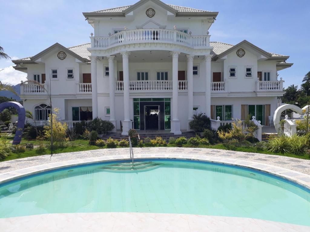 a large house with a large pool in front of it at Andres Resort in Nabas