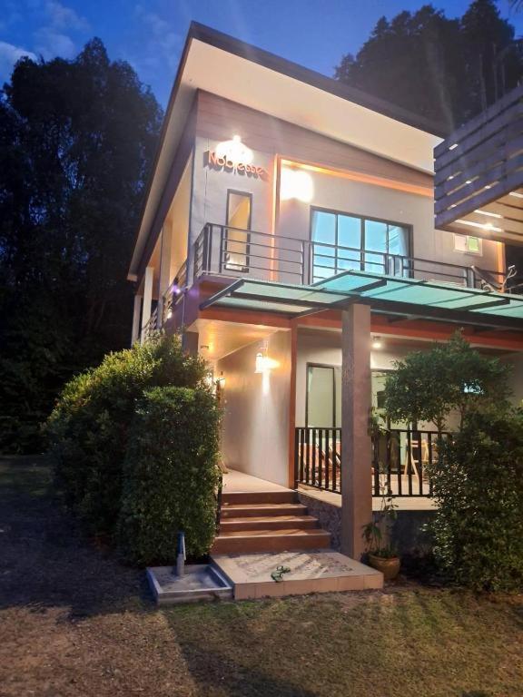 a house with a staircase in front of it at Lantanoblesse in Ko Lanta