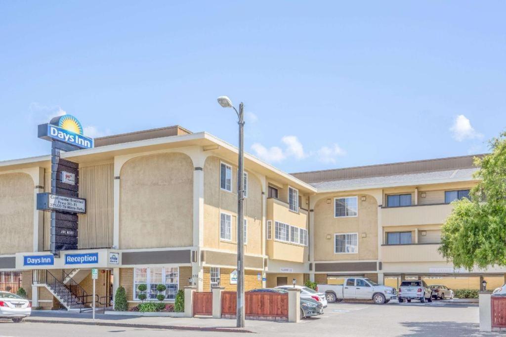 a large building with a street sign in front of it at Days Inn by Wyndham Eureka CA in Eureka