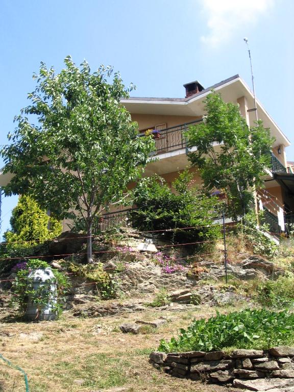 a house on the side of a hill with trees at B&B Pian Savin in Giaveno