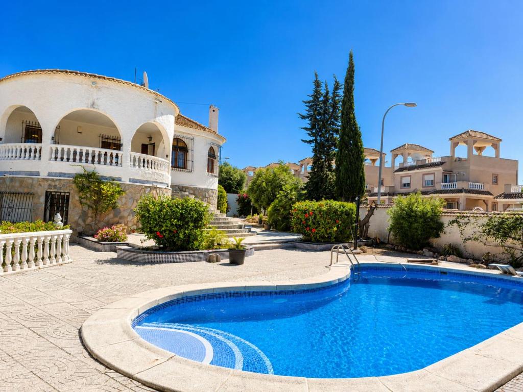 a swimming pool in front of a house at Private Pool Villa La Siesta in La Mata