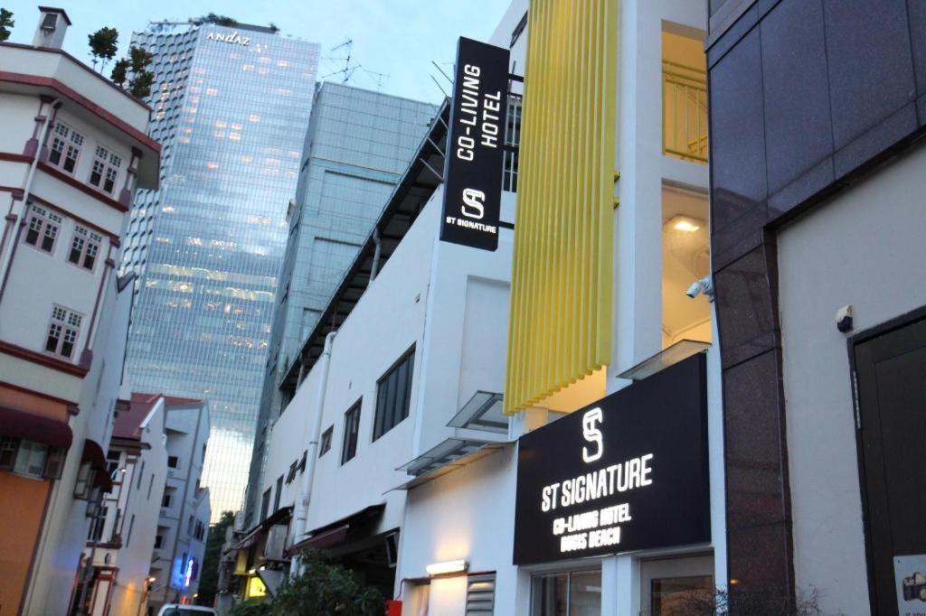 a street with tall buildings in a city at ST Signature Bugis Beach in Singapore