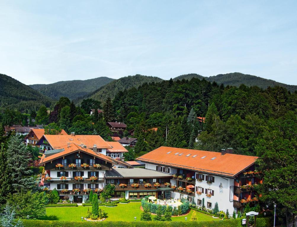 a large building with a mountain in the background at Hotel Alpenhof in Bad Wiessee