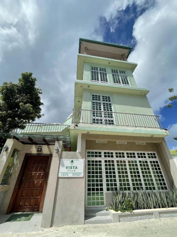 a building with a sign in front of it at Vista Villa in Hithadhoo