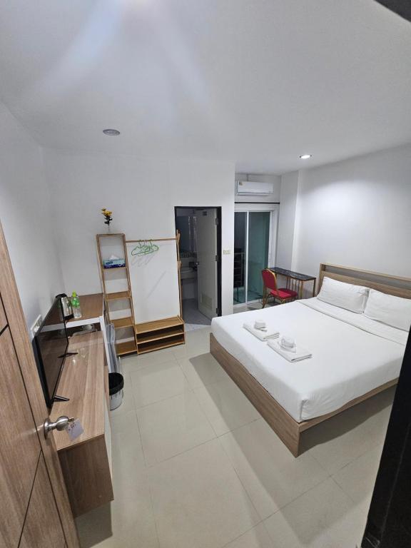 a bedroom with a bed and a desk and a chalkboard at 07 Antalya Boutique Hotel in Patong Beach