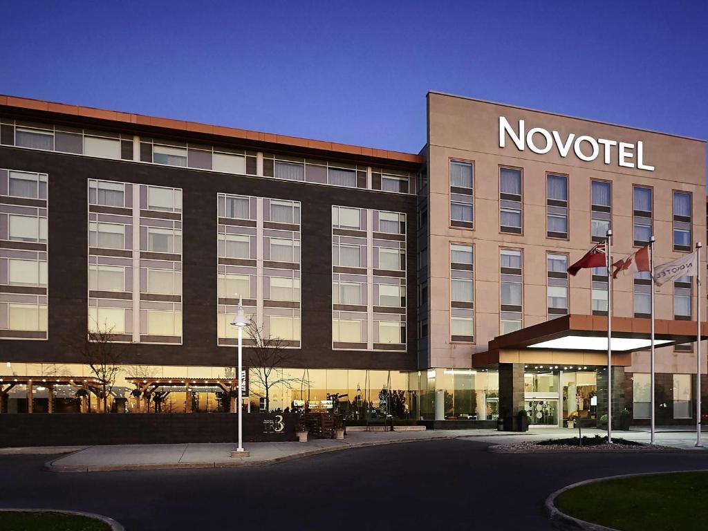 a no hotel building with flags in front of it at Novotel Toronto Vaughan Centre in Vaughan