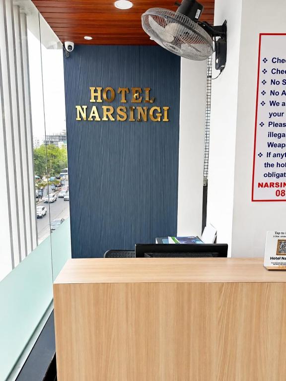 a sign for ahotel mariner on a wall in a office at Hotel Narsingi in Gundipet