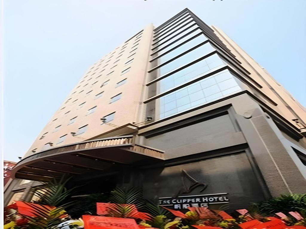 a tall building with a lot of windows at The Clipper Hotel in Dongguan
