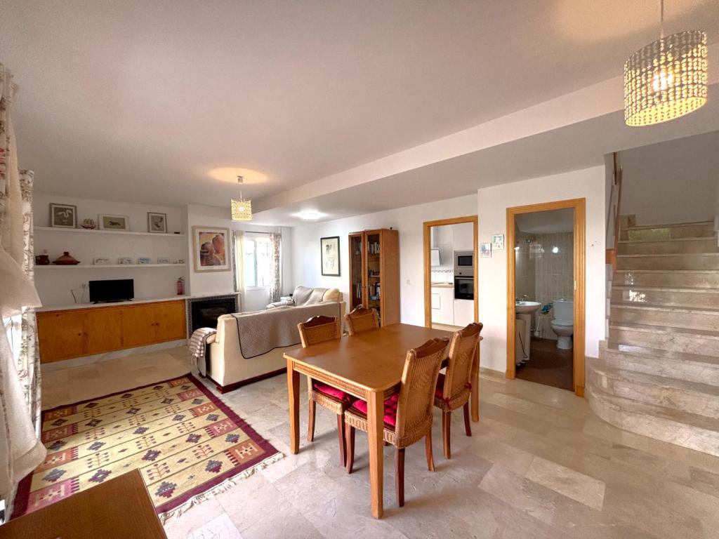 a living room with a table and a couch at Los Enebros in Cartaya
