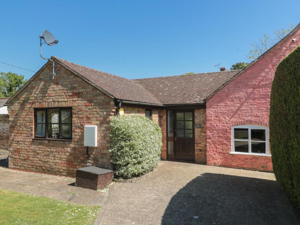 a red brick house with a driveway at Walk Close in Gloucester
