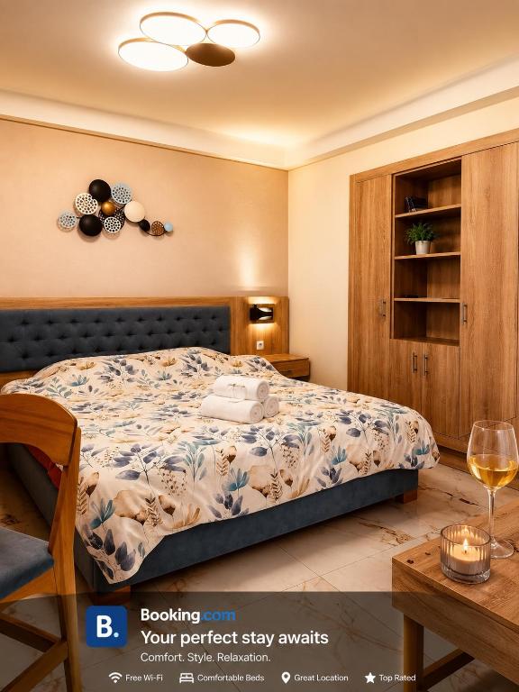 a bedroom with a bed and a glass of wine at Marble House in Kavála