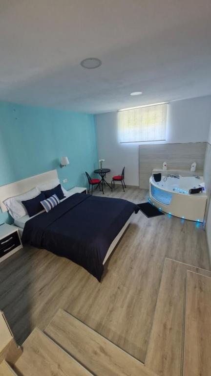 a bedroom with a bed and a table and a tub at Serendipia 52 in Suances