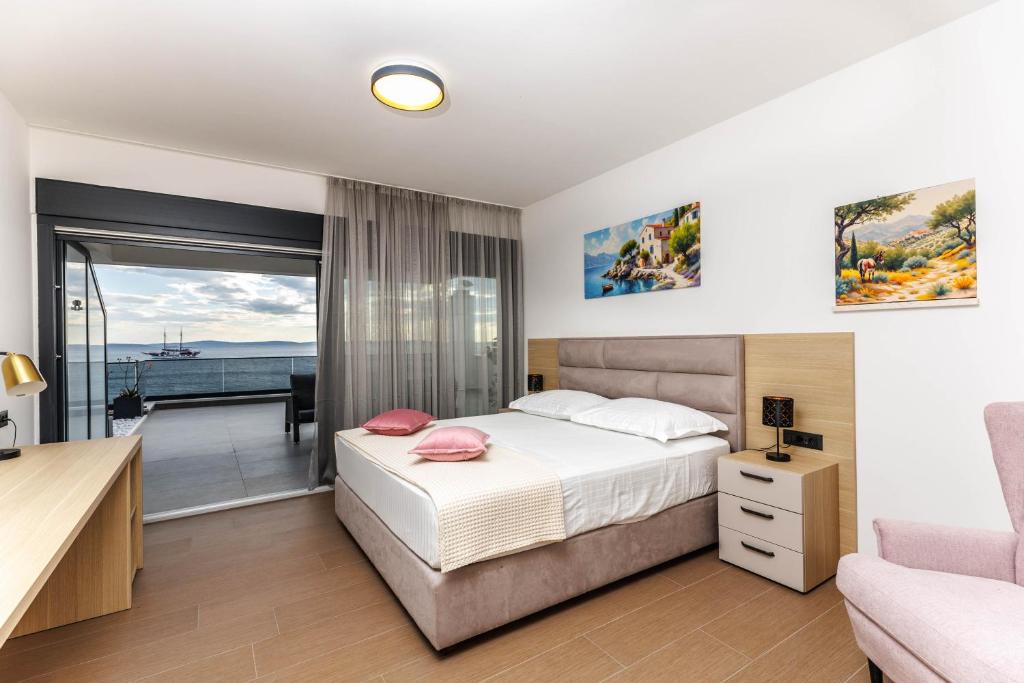 a bedroom with a bed and a balcony at Stella Maris Deluxe in Podstrana