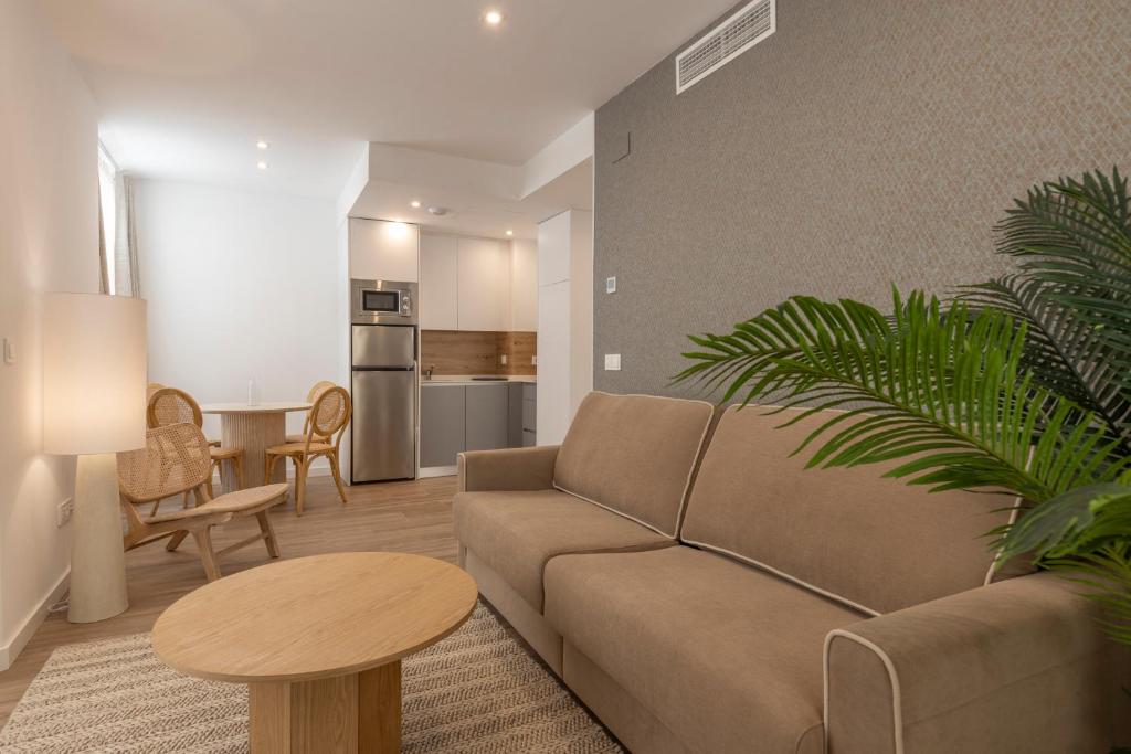 a living room with a couch and a table at BiBo Suites Casa Nawal in Granada