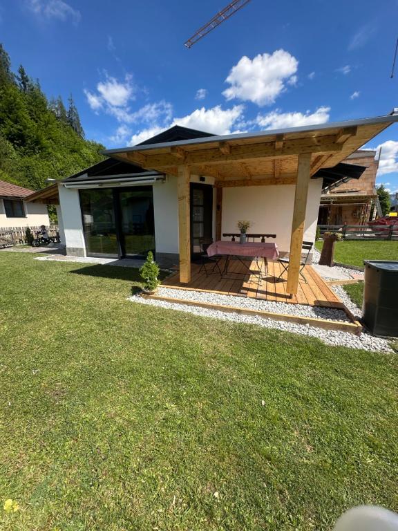 a house with a picnic table on a deck at Tiroler Bergchalet bei Kitzbühel in Kirchdorf in Tirol