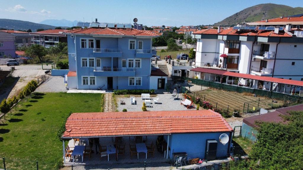 a large blue house with a red roof at Parli Hotel in Gokceada Town