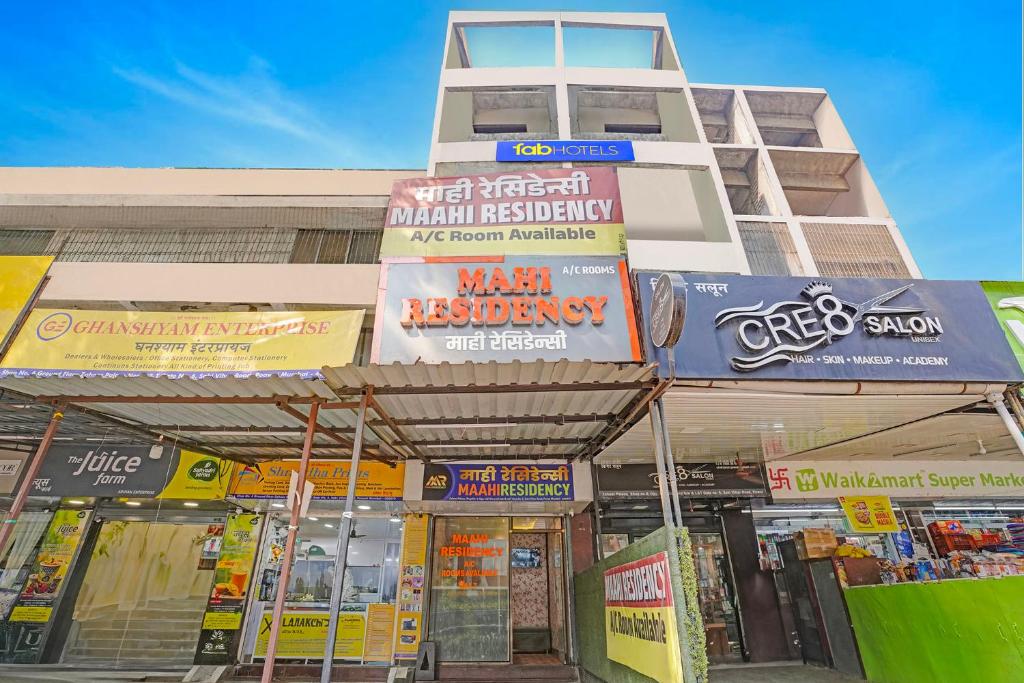 a building with many signs on the front of it at Via Maahi Residency in Mumbai