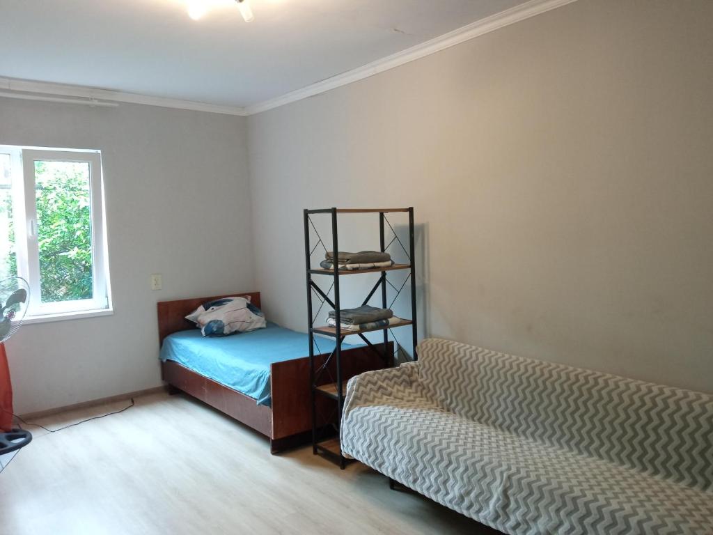 a room with a bed and a couch in it at studio with a fireplace in Zugdidi